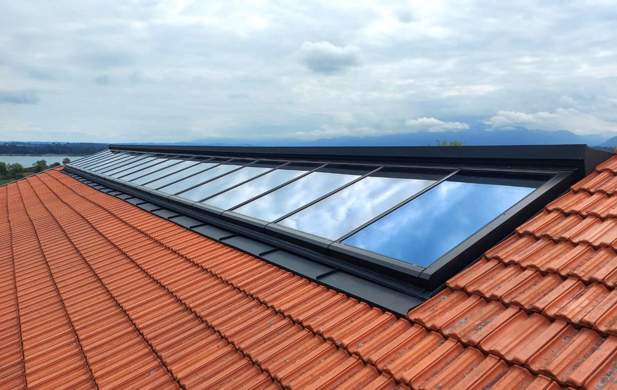 Continuous rooflight near the ridge, mounted on a roof of a building at Lake Chiemsee, Germany