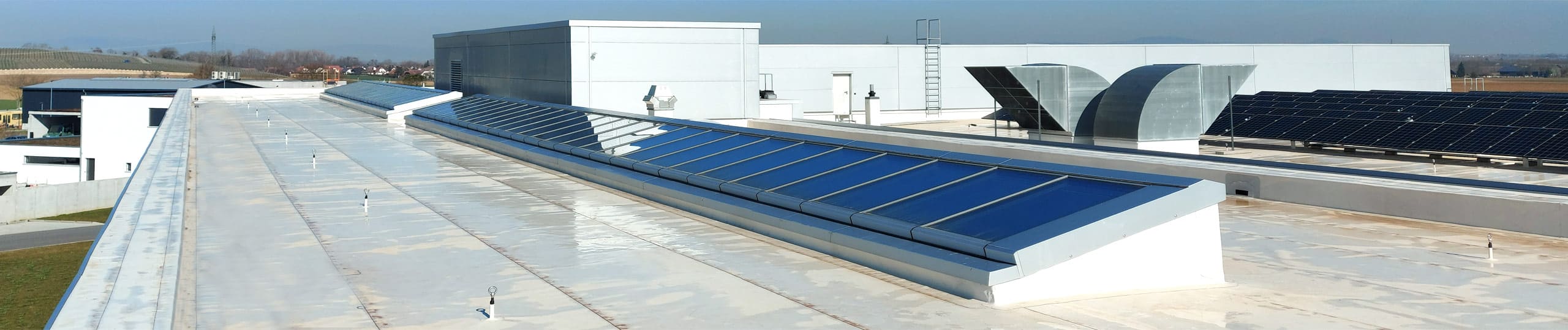 Monopitch rooflights on the flat roof of a company building